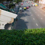 Red light camera looking over a city street.