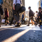 People crossing over an intersection in New York.