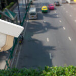 A red light camera looking over traffic