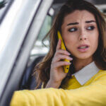 A woman talking on the phone while driving